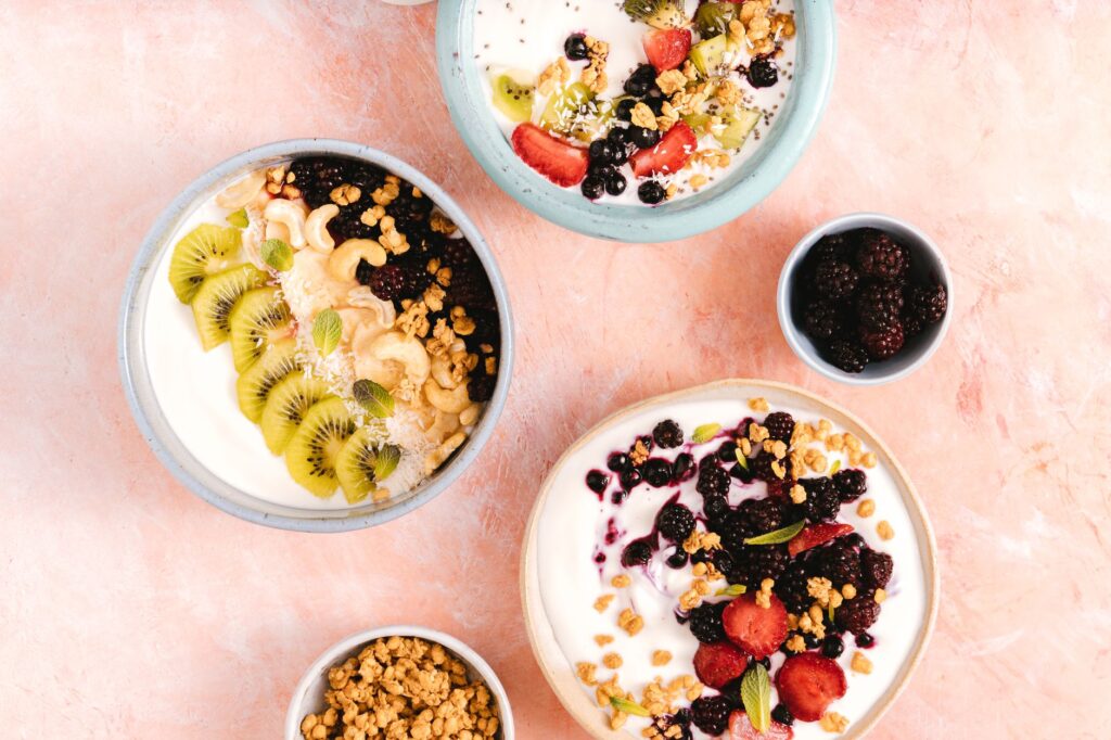 Yogurt bowls topped with fresh fruits, granola, and berries — common probiotic food sources for gut health