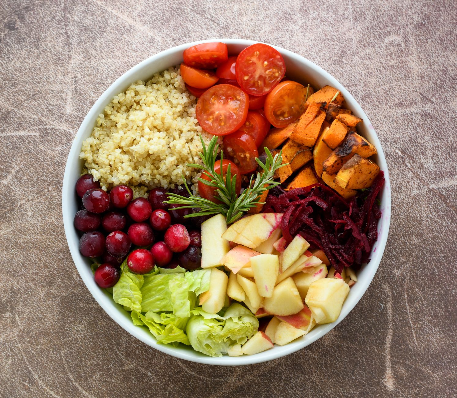 A vibrant Buddha bowl filled with quinoa, fresh fruits, and colorful vegetables for a gut health diet plan