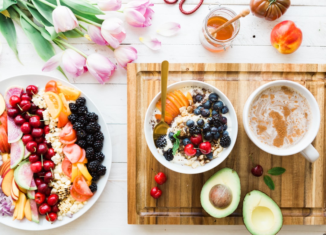 Colorful spread of gut health foods including berries, oats, fruit bowl and avocado — best foods for gut health