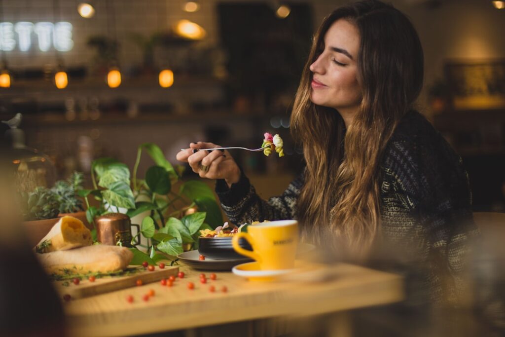 Woman eating a healthy meal slowly and mindfully at a restaurant table