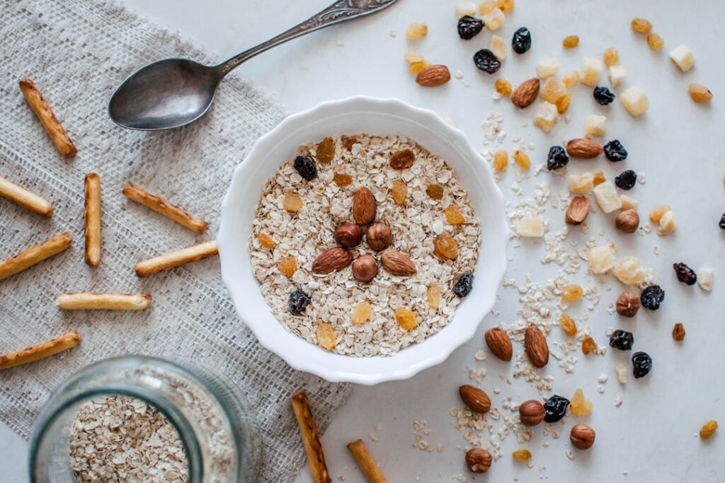Bowl of oats with nuts, seeds, and dried fruit — fiber-rich whole foods that support gut health and the microbiome