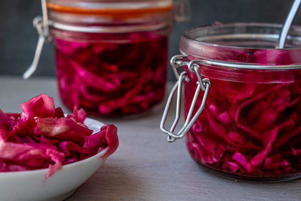 Pickled red cabbage sauerkraut in glass clamp jars, a probiotic fermented food for supporting gut health naturally