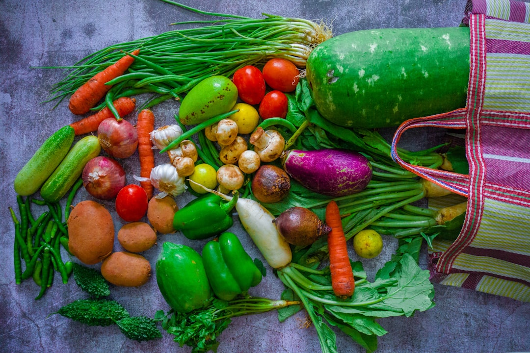 Fresh colorful vegetables and produce spilling from a market bag, representing healthy foods for gut health