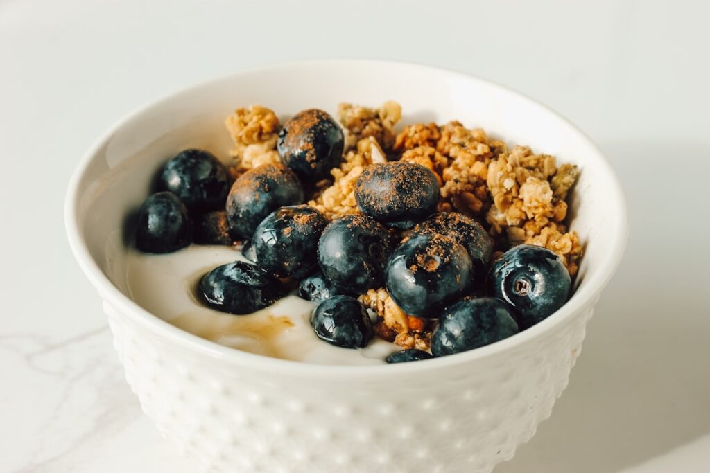 Bowl of yogurt with blueberries and granola — a natural source of probiotics for gut health